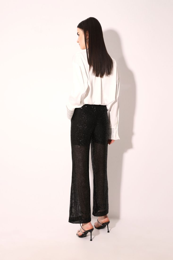 Pantaloni monocolour flare con paillettes